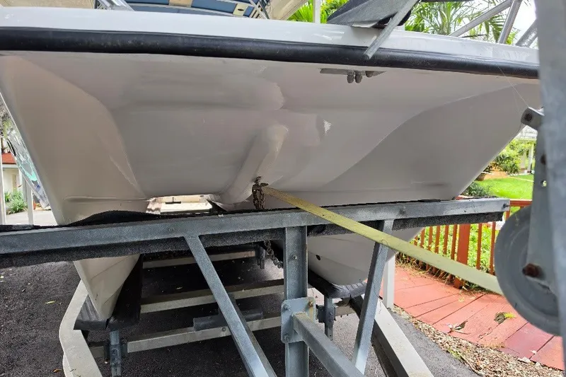 Slide: The Image of 2006 Twin Vee 26 Express boat on trailer, viewed from the rear, showcasing hull design. - 7