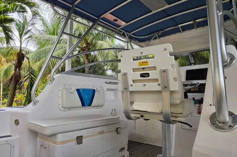 Slide: The Image of Interior of a 2006 Twin Vee 26 Express boat with seating and steering area. - 50