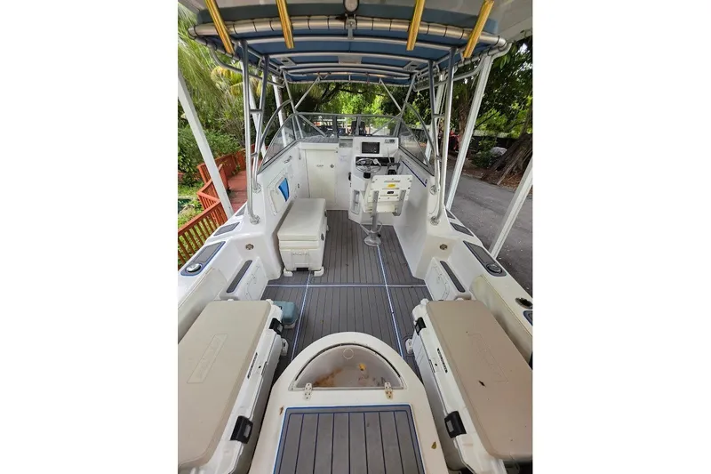 Slide: The Image of 2006 Twin Vee 26 Express boat interior with seating and steering console. - 27