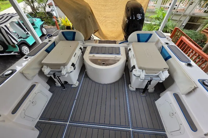 Slide: The Image of 2006 Twin Vee 26 Express boat interior with seating and storage compartments. - 28