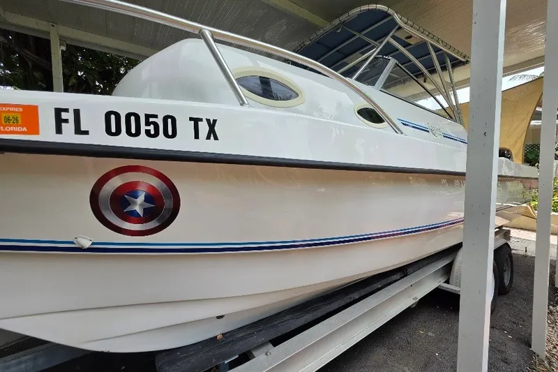 Slide: The Image of 2006 Twin Vee 26 Express boat with Florida registration, parked on a trailer. - 9