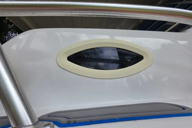 Slide: The Image of 2006 Twin Vee 26 Express boat window detail with metal railing. - 11