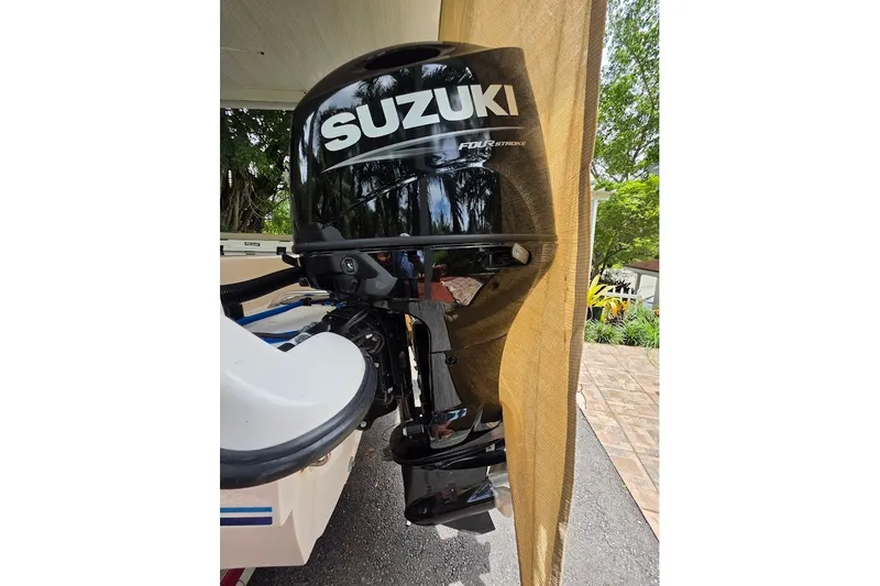 Slide: The Image of Suzuki four-stroke outboard motor on a 2006 Twin Vee 26 Express boat. - 18