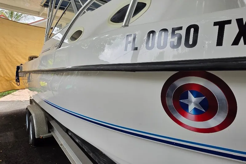 Slide: The Image of 2006 Twin Vee 26 Express boat with Captain America shield decal and registration number. - 14