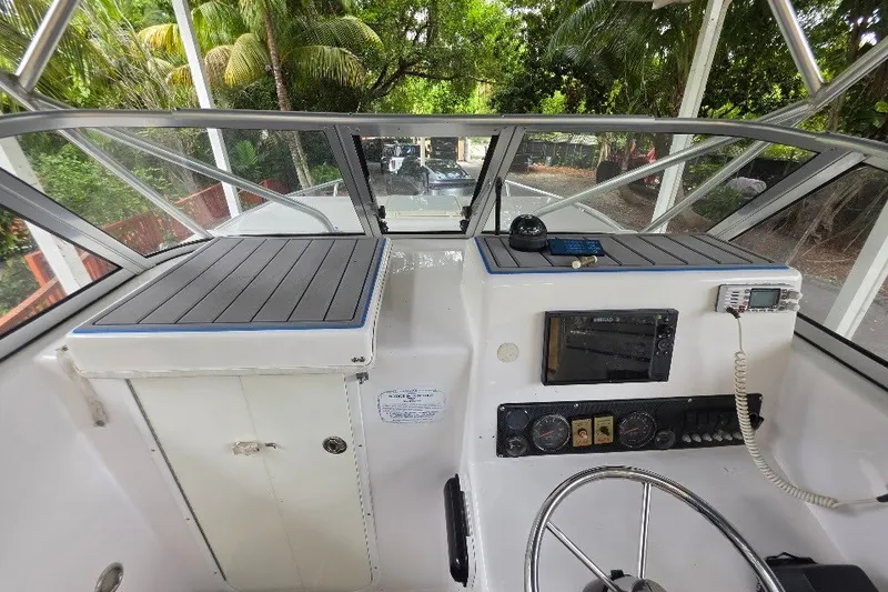 Slide: The Image of 2006 Twin Vee 26 Express boat cockpit with steering wheel and control panel. - 46