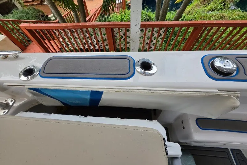 Slide: The Image of 2006 Twin Vee 26 Express boat deck with rod holders and seating. - 48