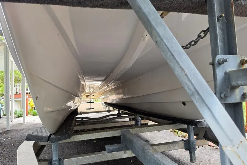 Slide: The Image of 2006 Twin Vee 26 Express boat hull on trailer, showcasing sleek design and sturdy construction. - 8