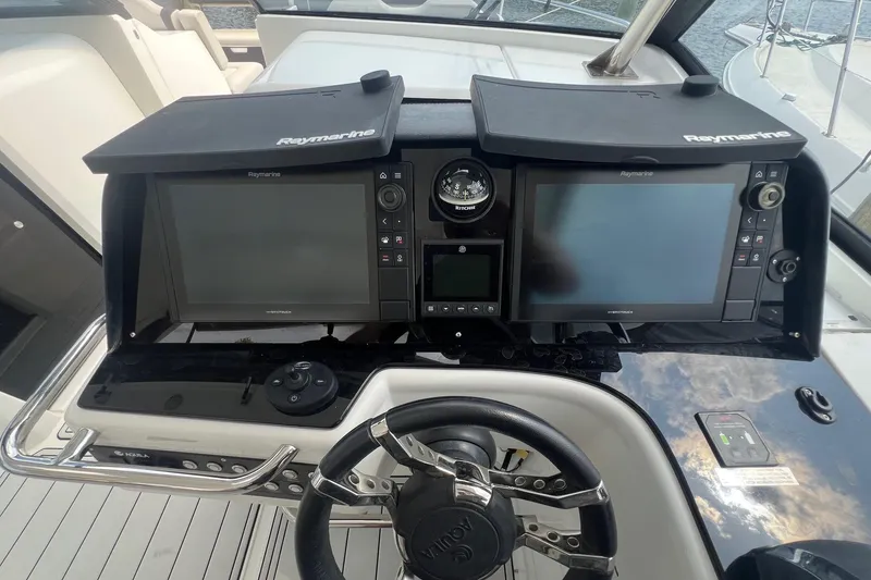 Slide: The Image of Helm of 2019 Aquila 36 Sport with Raymarine navigation displays and steering wheel. - 21