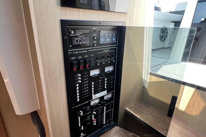 Slide: The Image of Electrical control panel on a 2019 Aquila 36 Sport yacht, featuring 12V and 120V systems. - 28