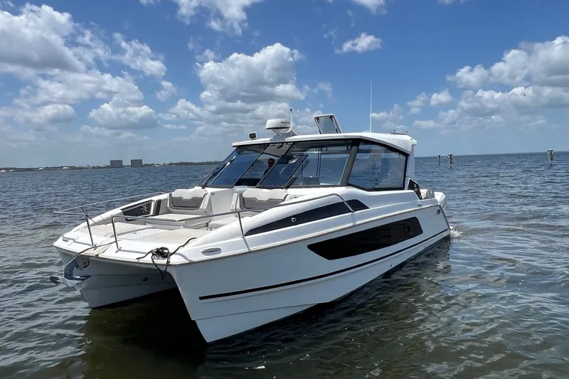 The Image of 2019 Aquila 36 Sport catamaran on calm water under a partly cloudy sky. - 0