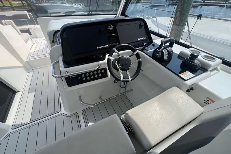 Slide: The Image of Helm of 2019 Aquila 36 Sport boat with modern controls and navigation system. - 22