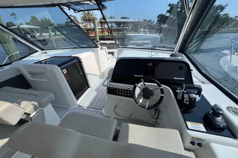 Slide: The Image of Interior view of 2019 Aquila 36 Sport boat cockpit with steering wheel and navigation equipment. - 14