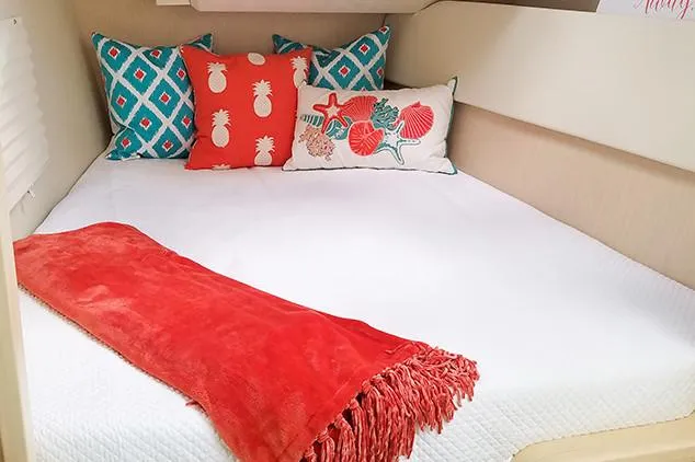 Slide: The Image of Manufacturer Provided Image: Cozy bed in 2019 Aquila 36 Sport with colorful pillows and red throw blanket. - 32