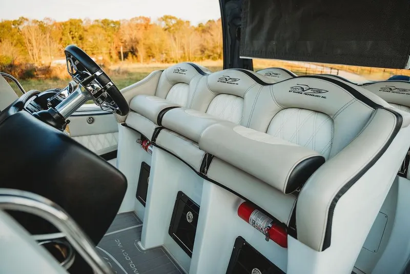 Slide: The Image of Luxurious interior of a 2018 MTI 57 boat with plush seating and sleek steering wheel. - 30