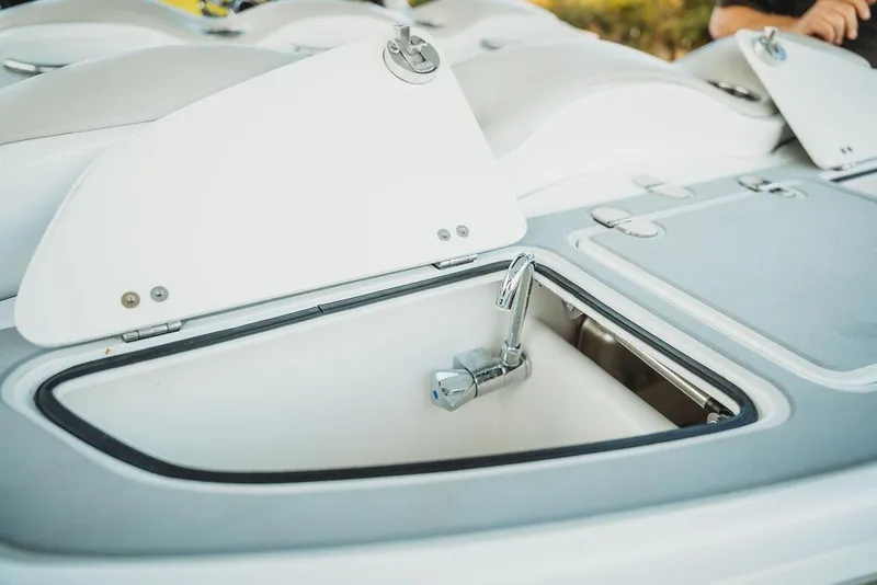 Slide: The Image of Open storage compartment with faucet on 2018 MTI 57 boat deck. - 70
