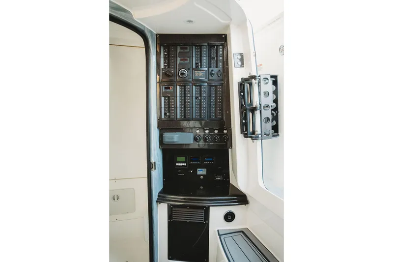 Slide: The Image of Control panel inside 2018 MTI 57 boat, featuring switches and electronic displays. - 58