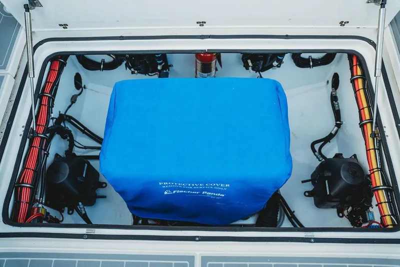 Slide: The Image of Engine compartment of 2018 MTI 57 boat with blue protective cover. - 73