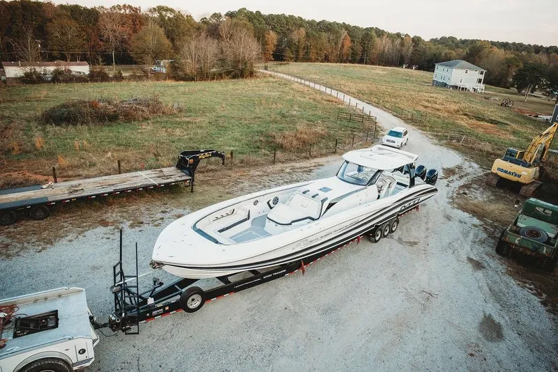 Slide: The Image of Aerial view of a 2018 MTI 57 boat on a trailer in a rural setting. - 77
