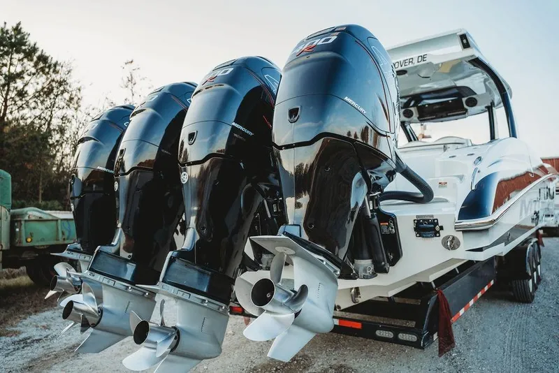 Slide: The Image of 2018 MTI 57 boat with four powerful Mercury outboard engines on a trailer. - 74