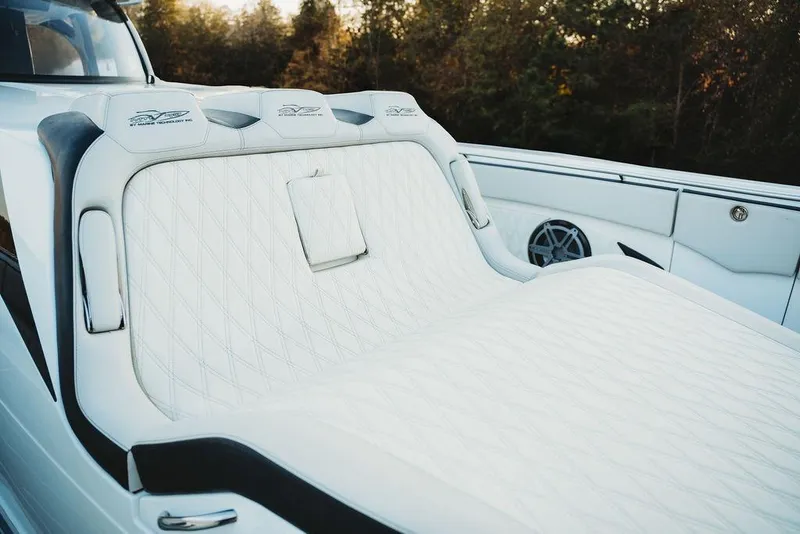 Slide: The Image of Luxurious white seating on a 2018 MTI 57 boat, featuring elegant diamond stitching. - 66