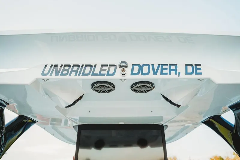 Slide: The Image of 2018 MTI 57 boat with "Unbridled Dover, DE" text and speakers on the stern. - 39