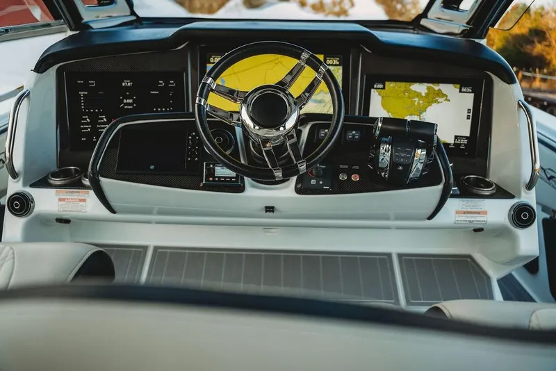 Slide: The Image of Luxurious 2018 MTI 57 yacht cockpit with advanced navigation displays and sleek steering wheel. - 28