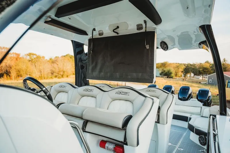 Slide: The Image of Interior of a 2018 MTI 57 boat with luxurious seating and multiple engines. - 29