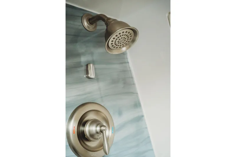 Slide: The Image of Modern showerhead and control panel in a sleek bathroom, MTI model 57, 2018. - 55