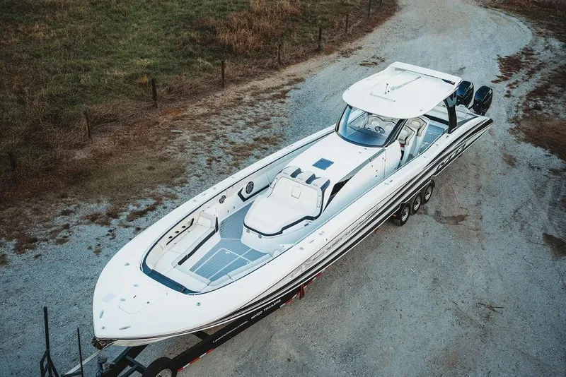 Slide: The Image of Aerial view of a 2018 MTI 57 luxury boat on a trailer, parked on a gravel path. - 75