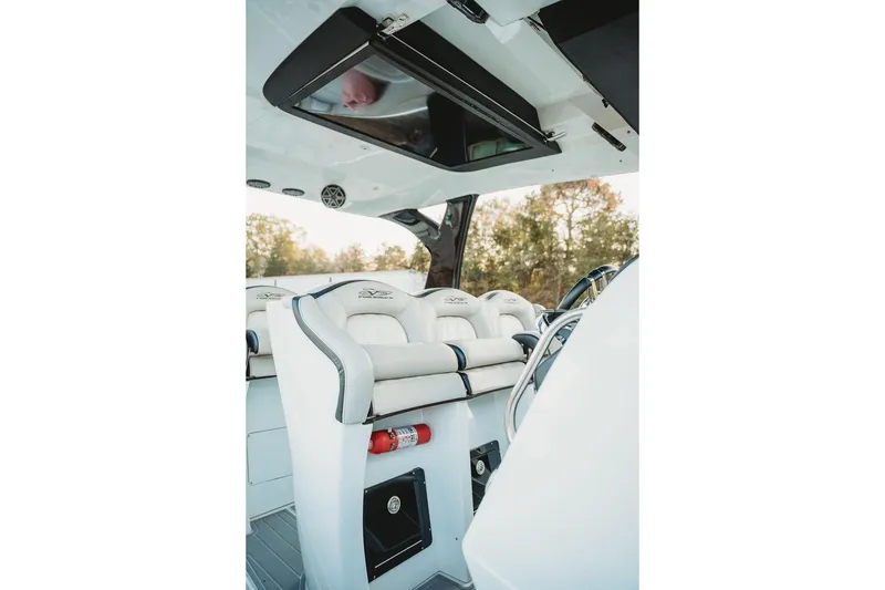 Slide: The Image of Interior of 2018 MTI 57 boat with white seating and steering wheel. - 35