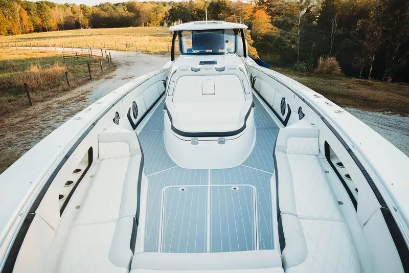 Slide: The Image of Luxurious 2018 MTI 57 boat with spacious white seating and sleek design. - 62