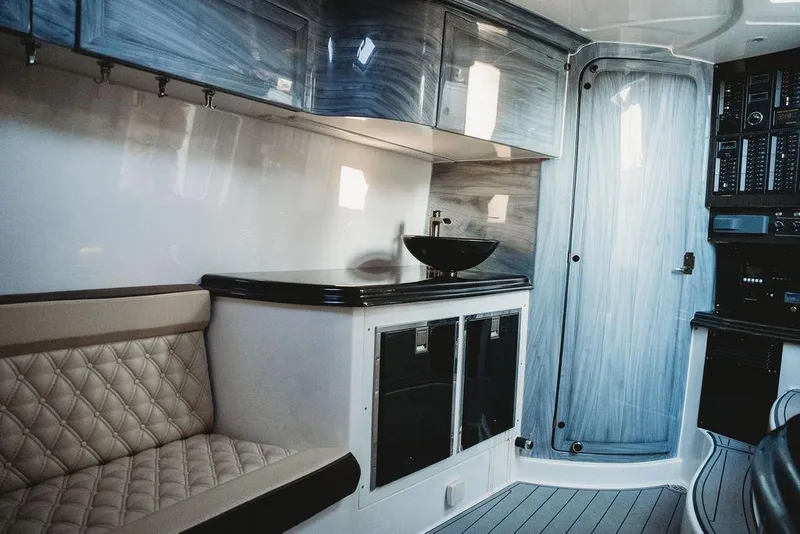 Slide: The Image of Luxurious interior of a 2018 MTI 57 boat with modern seating and sleek cabinetry. - 40