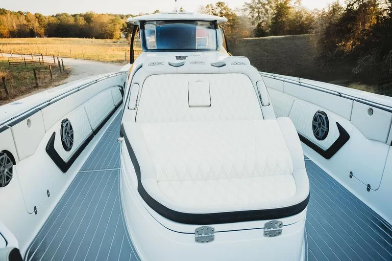 Slide: The Image of Luxurious 2018 MTI 57 boat interior with plush seating and scenic countryside backdrop. - 65