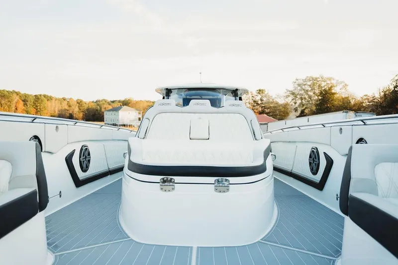 Slide: The Image of Luxurious 2018 MTI 57 yacht interior with sleek white seating and modern design. - 59