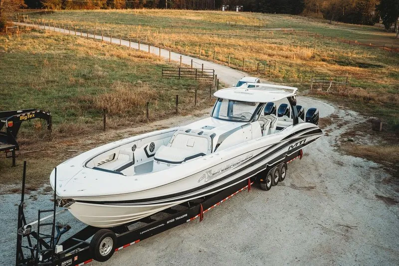 Slide: The Image of 2018 MTI 57 boat on trailer in rural setting, ready for transport. - 18