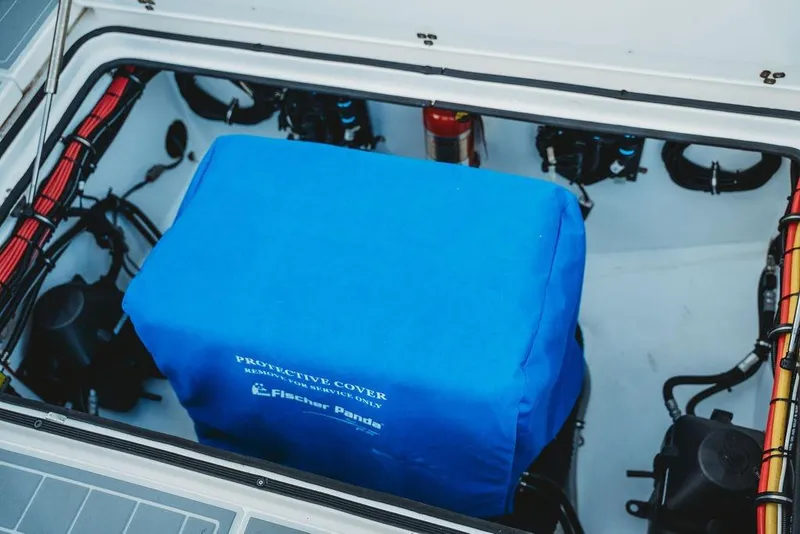 Slide: The Image of Engine compartment of 2018 MTI 57 boat with blue protective cover and visible wiring. - 71