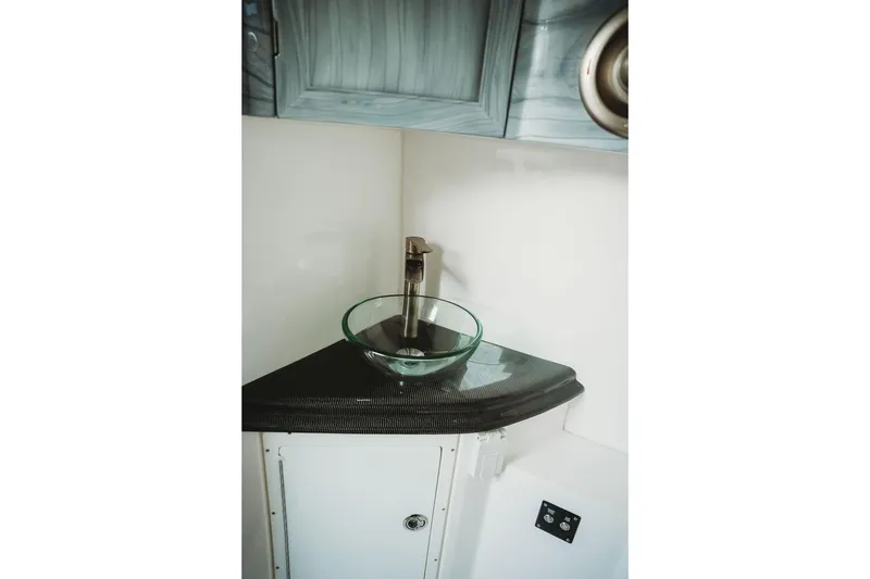 Slide: The Image of Modern bathroom sink with glass bowl and sleek faucet in MTI 57, 2018 model. - 53