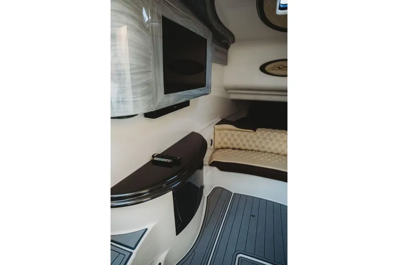Slide: The Image of Luxurious interior of 2018 MTI 57 boat with TV and cushioned seating. - 56