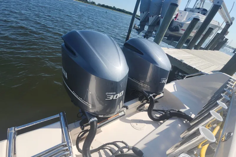 Slide: The Image of 2021 Grady-White Canyon 306 with twin Yamaha 300 engines docked by the water. - 30