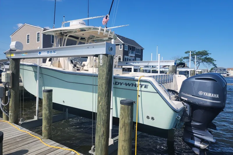 Slide: The Image of 2021 Grady-White Canyon 306 boat with Yamaha engines docked at a marina. - 6