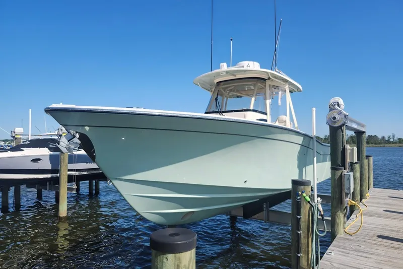 Slide: The Image of 2021 Grady-White Canyon 306 boat docked on a sunny day. - 4