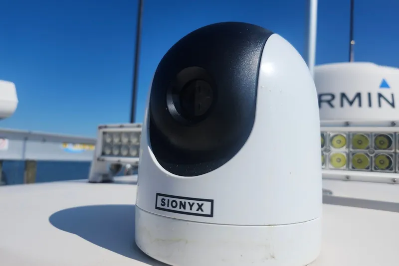 Slide: The Image of SIONYX camera on 2021 Grady-White Canyon 306 boat, with Garmin equipment in background. - 22