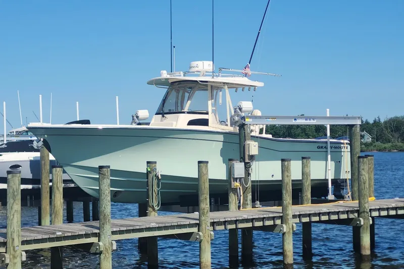 Slide: The Image of 2021 Grady-White Canyon 306 boat docked on a sunny day. - 9