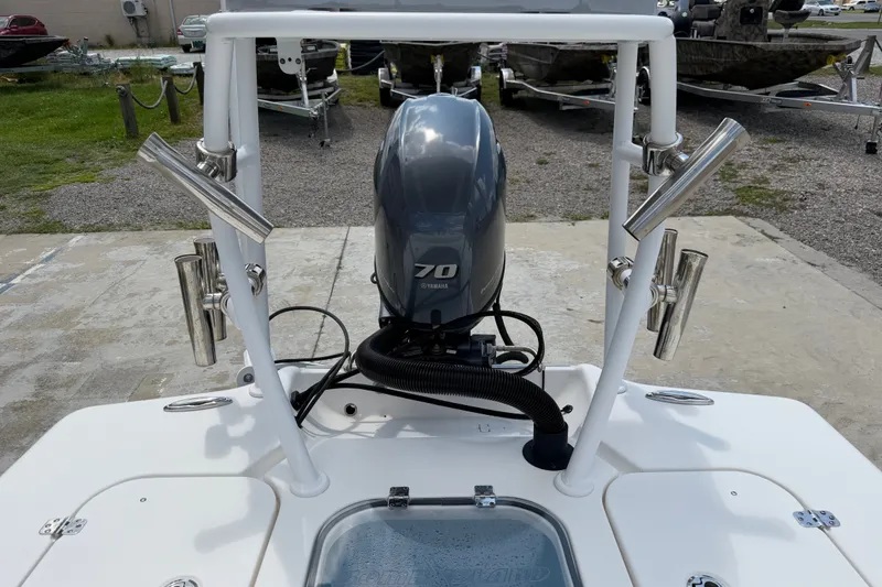 Slide: The Image of 2018 Bomb Island 160 Side Console boat with Yamaha 70 engine, docked outdoors. - 14