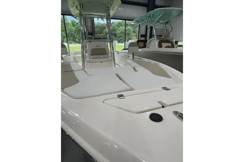 Slide: The Image of 2026 Bulls Bay 2400 boat interior with seating and storage, displayed indoors. - 4