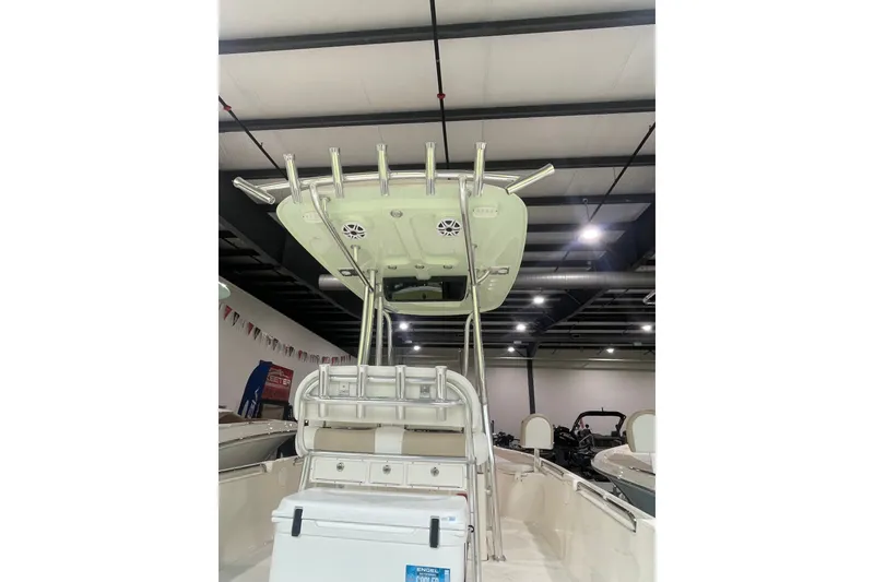 Slide: The Image of 2026 Bulls Bay 2400 boat interior with T-top and rod holders in showroom. - 11