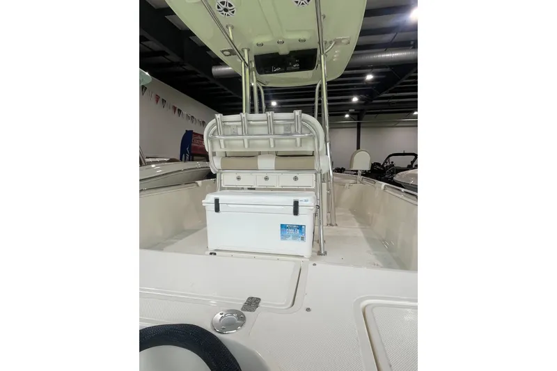 Slide: The Image of 2026 Bulls Bay 2400 boat interior with seating and storage, displayed indoors. - 12