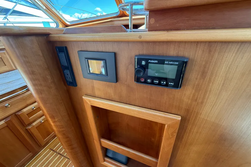 Slide: The Image of 2018 Sabre 45 Salon Express interior with Fusion MS-NRX300 audio system and wooden cabinetry. - 46