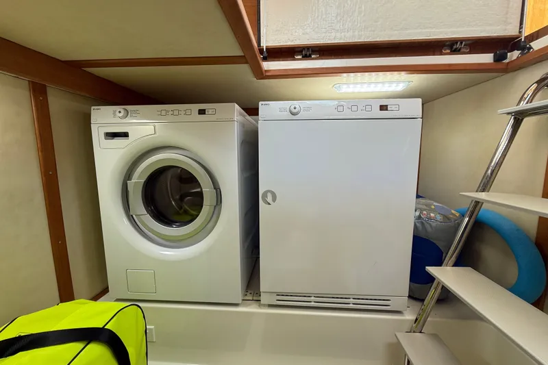 Slide: The Image of Laundry area inside 2018 Sabre 45 Salon Express yacht with washer and dryer. - 67
