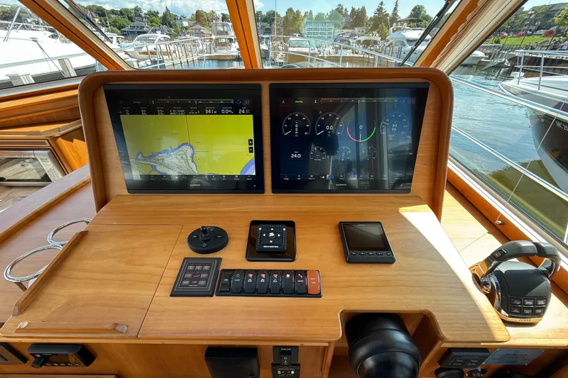 Slide: The Image of 2018 Sabre 45 Salon Express helm with dual Garmin displays and navigation controls. - 43
